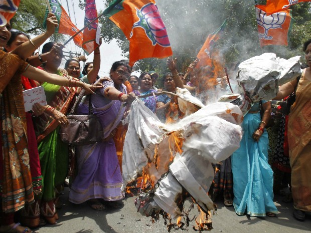 Mulheres protestam queimando representação do ministro chefe de Estado onde as garotas sofreram abuso e foram enforcadas na Índia (Foto: Jitendra Prakash/Reuters)