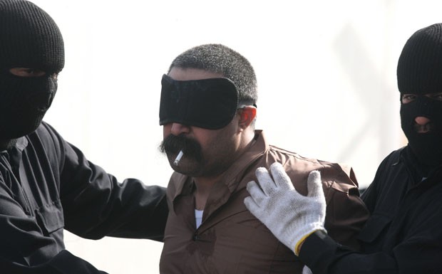 Saudita condenado à morte fuma um cigarro antes de sua execução no Kuwait (Foto: Yasser Al-Zayyat/AFP)