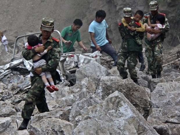 Soldados chineses ajudam a retirar crianças de locais afetados pelo tremor em Zhaotong (Foto: Stringer/Reuters)