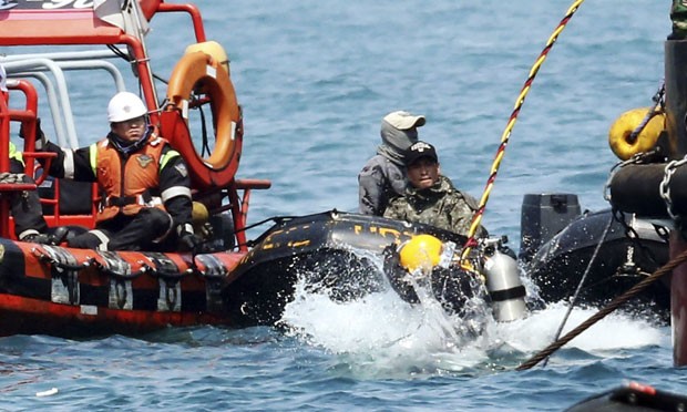 Mergulhador pula no mar na região onde balsa afundou na Coreia do Sul durante trabalhos de resgate das vítimas nesta sexta-feira (25) (Foto: Yonhap/Reuters)