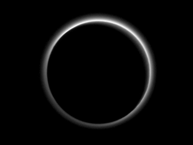 Imagem divulgada pela Nasa nesta sexta-feira (24) mostra a atmosfera de Plutão iluminada pela luz do Sol, que está atrás do planeta-anão. A imagem foi feita quando a sonda New Horizons estava a cerca de 2 milhões de km de Plutão  (Foto: Nasa/JHUAPL/SwRI via AP)