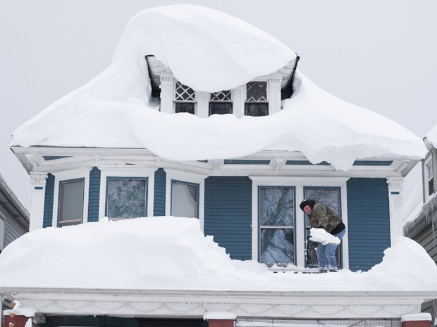Tom Wilczak retira neve do telhado de sua casa em Buffalo, NY, na quinta-feira (20) (Foto: Reuters/Aaron Lynett)