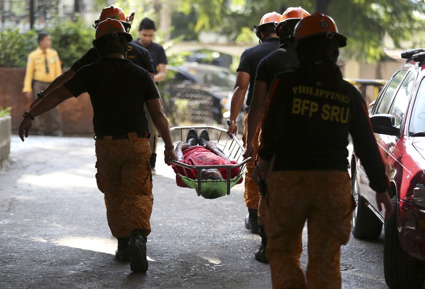 Equipes de resgate ensaiam o socorro a uma vítima durante exercício de evacuação em casos de terremoto em Makati, nas Filipinas