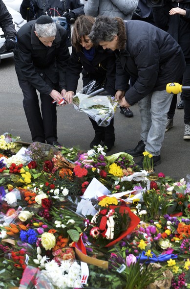A prefeita de Paris, Anne Hidalgo (Centro), deixa flores em frente ao café, cena do primeiro ataque no fim de semana, em Copenhagen, na Dinamarca