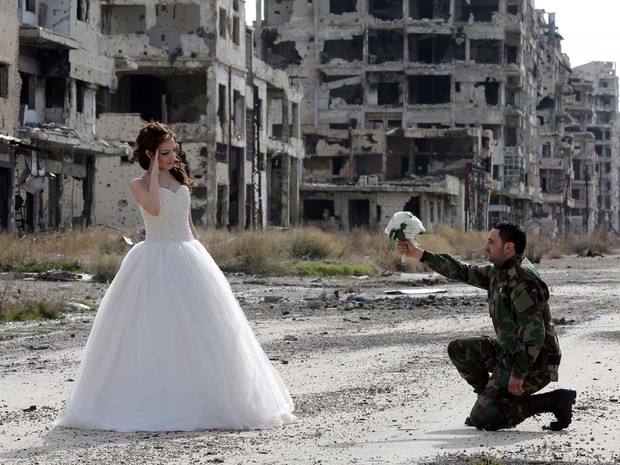 Nada Merhi e Hassan Youssef posam para ensaio fotográfico em área devastada pela guerra na Síria na cidade de Homs (Foto: JOSEPH EID / AFP)