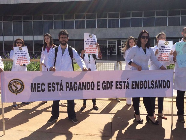 Médicos residentes da rede pública do DF seguram cartazes em protesto para cobrar repasse de aumento nas bolsas dado pelo MEC (Foto: Mateus Vidigal/G1) Médicos residentes da rede pública do DF seguram cartazes em protesto para cobrar repasse de aumento nas bolsas dado pelo MEC (Foto: Mateus Vidigal/G1)