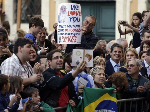 Fiel com a bandeira do Brasil aguarda a saída do Papa Francisco da missa de canonização de José de Anchieta, em Roma (Foto: Gregorio Borgia/AP)
