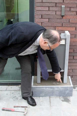 Patrick Arnoum, prefeito de Zedelgem, mostra a caixa de correio que foi forçada na frente da prefeitura de Zedelgem (Foto: Yves Logghe/AP )