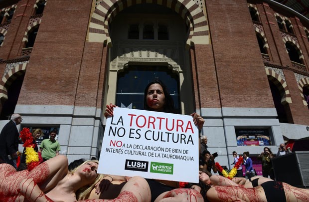 Ativistas seminuas protestam contra as touradas nesta quinta-feira (23) em Barcelona, na Espanha (Foto: Lluis Gene/AFP)