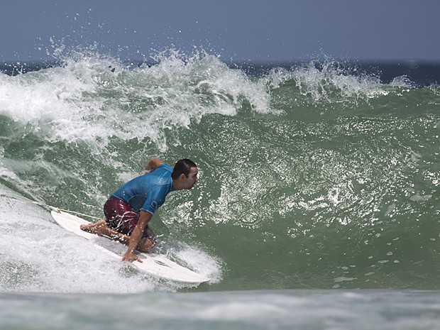 Cofundador do AdaptSurf, Henrique Saraiva, não tem os movimentos da cintura para baixo e surfa de joelhos (Foto: Felipe Dana/AP)