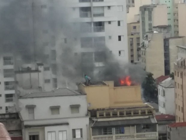 Moradores saem de prédio pelo telhado (Foto: Silvia Vitoria de Oliveira/Vc no G1)
