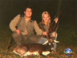 Casal Matsunaga posa com armas do acervo (Foto: Reprodução/TV Globo)