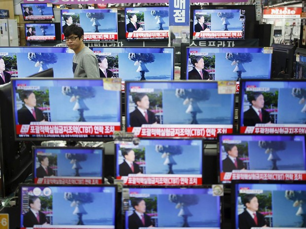 Em uma loja de Seul, capital da Coreia do Sul, vendedor passa entre televisores noticiando o suposto teste nuclear com bomba de nitrogênio realizado pela Coreia do Norte perto da fronteira com seu vizinho do sul (Foto: Kim Hong-ji/Reuters)