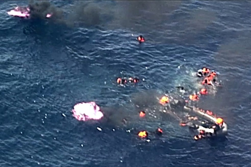 Migrantes são resgatados no Mar Mediterrâneo após embarcação pegar fogo (Foto: Handout / Forca Aerea Portuguesa / AFP)
