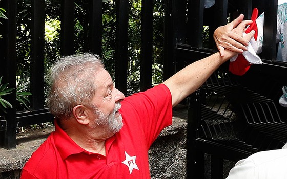 O ex-presidente Lula cumprimenta militantes do PT em frente ao seu prédio em São Bernardo do Campo dia 4 de março (Foto: AP Photo/Andre Penner)