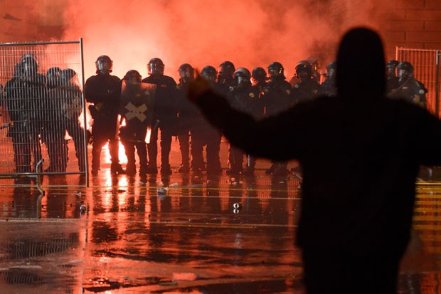 Membro do 'Black Bloc' encara policiais durante confusão durante o 'Tanz dich frei' (ou 'liberte-se pela dança') (Foto: Fabrice Coffrini/AFP)