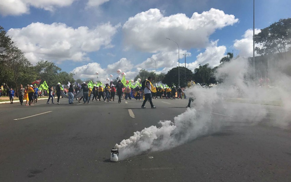 Manifestantes soltam bomba de fumaça na N1, no Eixo Monumental, durante ato contra governo Temer (Foto: Letícia Carvalho/G1)