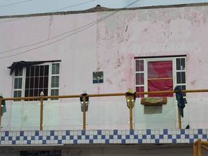 Porta da casa foi arrombada durante resgate das crianças (Foto: Catarina Costa/G1)