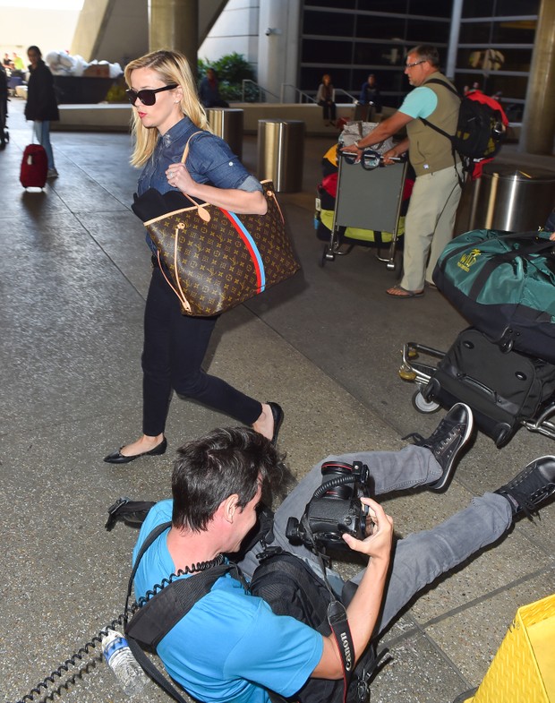 Reese Witherspoon observa paparazzo cair em aeroporto em Los Angeles, nos Estados Unidos (Foto: AKM-GSI/ Agência)