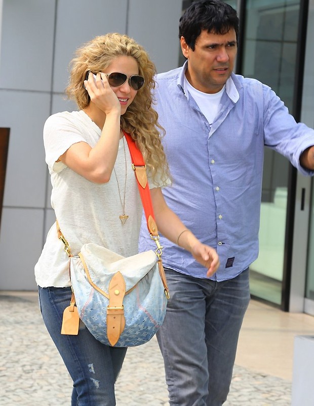 Shakira with a denim Louis Vuitton Purse