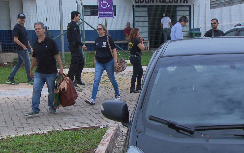 Policiais deixam Centro Médico da PM com malotes contendo documentos apreendidos na operação Mr. Hyde (Foto: TV Globo/Reprodução)