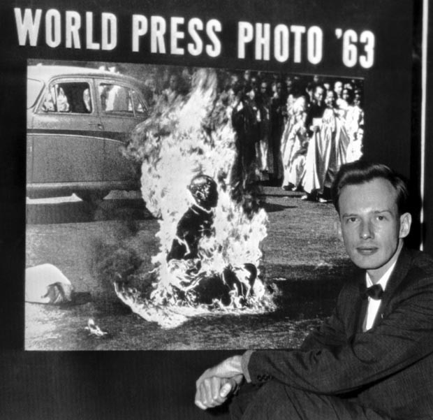 O fotógrafo posa com a imagem de sua autoria após receber prêmio do World Press Photo de 1963 em Haia, Holanda (Foto: AP/Arquivo)