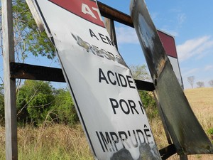 Placa de sinalização às margens da rodovia em péssimo estado de conservação (Foto: Caroline Aleixo/G1)