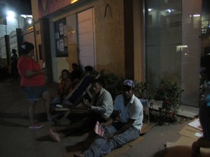 Beneficários estão dormindo em frente ao prédio anexo da Prefeitura de Macapá para conseguir uma senha (Foto: Fabíola Gomes/ G1)