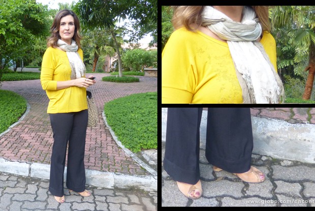 Fátima Bernardes escolheu calça de alfaiataria preta e blusa de manga comprida amarela para ir trabalhar. O cachecol bege é ótimo para espantar o friozinho típico do fim de tarde de outono! (Foto: Encontro com Fátima Bernardes/TV Globo)