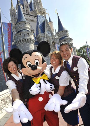 Guias do tour VIP da Disney posam com o personagem Mickey em frente ao Castelo da Cinderela (Foto: Divulgação/Disney)