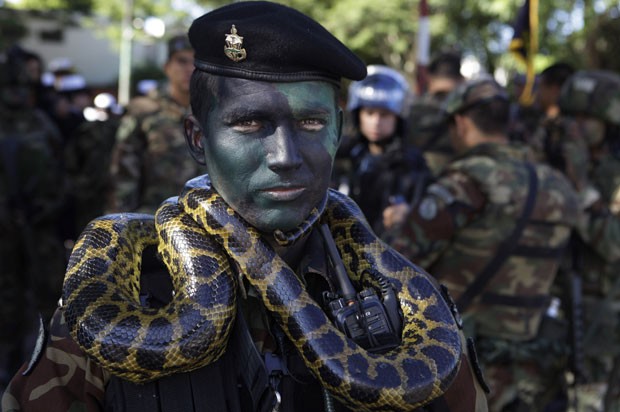 Outro militar mostrou bravura enrolando uma cobra em seu pescoço. O Paraguai celebrou 201 de sua independência em relação à Espanha (Foto: AP)