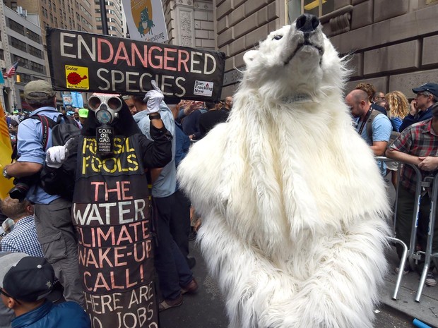 Homem vestido de urso polar participa do protesto 'Inunde a Wall Street', em Nova York, nos Estados Unidos. Manifestação ocorre na véspera do encontro da Cúpula do Clima da ONU, que deve reunir mais de 120 chefes de estado (Foto: Timothy A. Clary/AFP)