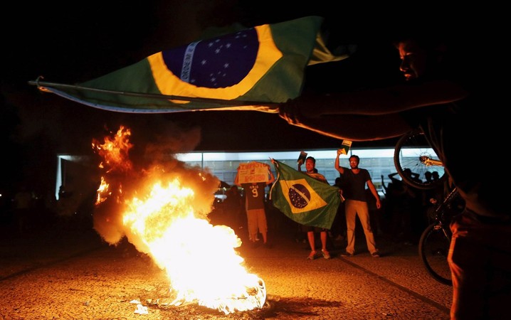 Manifestantes fazem fogueira e queimam boneco representando o ex-presidente Lula na Praça dos Três Poderes, em frente ao Palácio do Planalto, em Brasília, após a noemação de Lula como ministro