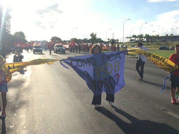 A geógrafa Jussara Rezende estende faixa com os dois filhos em Brasília em repúdio às decisões do juiz Sérgio Moro (Foto: Alexandre Bastos/G1)