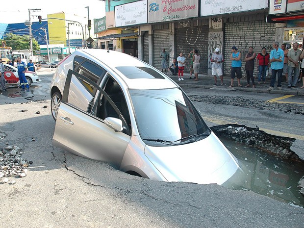 Um carro caiu em uma cratera na Rua Rua Elza Fagundes Teles, no Jardim Roberto, em Osasco, na Grande São Paulo, na manhã desta quinta-feira (6). Segundo a prefeitura do município, uma adutora da Companhia de Saneamento Básico do Estado de São Paulo (Sabesp) rompeu e formou a cratera. Técnicos da Secretaria de Serviços e Obras foram acionados para acompanhar a ocorrência. Até as 10h50, não havia informações de feridos. (Foto: Renato Silvestre/Estadão Conteúdo)