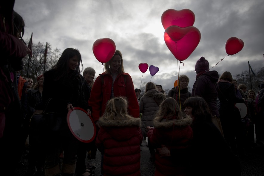 Women and girls hold love heart shaped balloons during a day of action event with a theme of love revolution and a focus on healthy relationships organized by the One Billion Rising movement at Marble Arch in London, on Valentine's Day, Saturday, Feb. 14,
