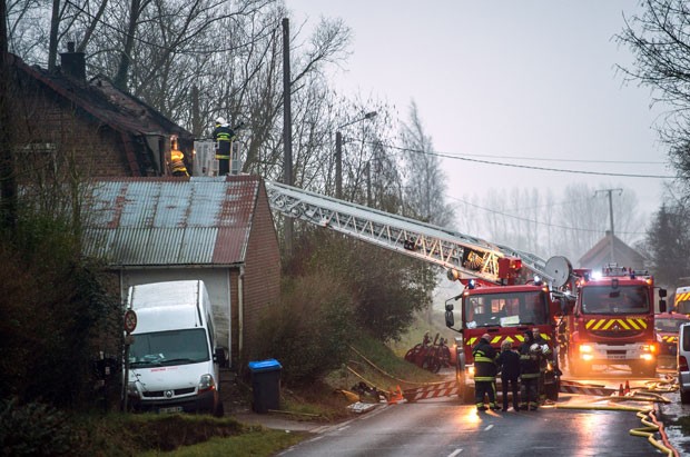 Bombeiros trabalham em local de incêndio onde uma mulher e seus quatro filhos morreram na madrugada desta terça-feira (10) em Saint-Jans-Cappel, no norte da França (Foto: Philippe Huguen/AFP)
