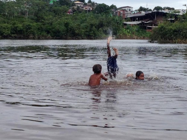 Garotos se divertem durante cheia do Rio Juruá (Foto: Genival Moura/G1)