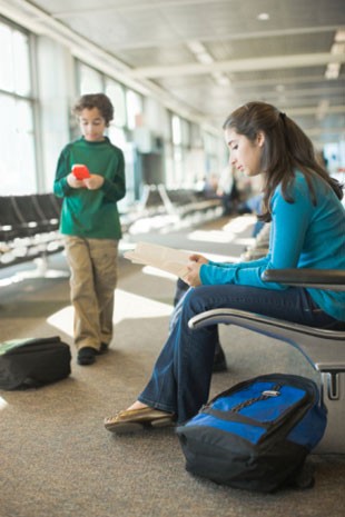 Adolescente e criança em aeroporto (Foto: Getty Images/Symphonie)