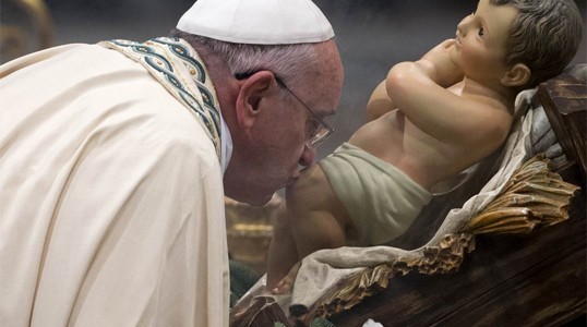 O Papa Francisco beija o joelho da estátua do menino Jesus ao chegar à Basílica de São Pedro, no Vaticano, para celebrar a tradicional missa de fim de ano