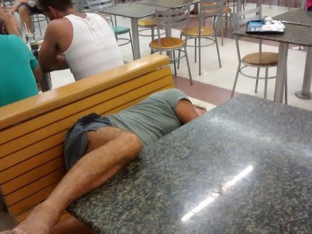 Homem chama atenção de curiosos ao dormir em praça de alimentação de hipermercado (Foto: Cássio Lyra/G1)