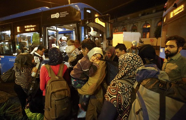  Em Budapeste, na Hungria, imigrantes entram em ônibus para leválos a Áustria e Alemanha  (Foto: Reuters/Leonhard Foeger)