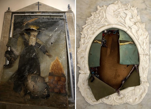 Quadro com a imagem de Santo Elias e outro com a cruxificação de Jesus fioram rasgados (Foto: Joseph Eid/AFP) Quadro com a imagem de Santo Elias e outro com a cruxificação de Jesus fioram rasgados (Foto: Joseph Eid/AFP)