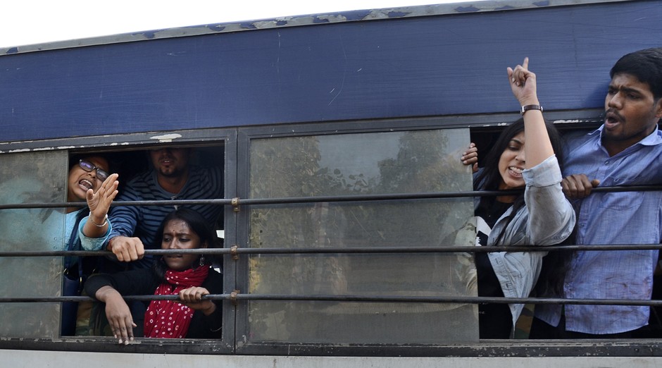 Student activists shout slogans from inside a police van after being detained during a protest against the Hindu Mahasabha, a right-winged Hindu organization, in New Delhi, India, Saturday, Feb. 14, 2015. The Hindu organization had said it would force cou