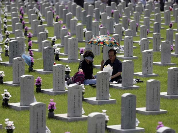 Casal sul-coreano visita túmulo de familiar morto durante a Guerra da Coreia (1950-1953). (Foto: Lee Jin-man / AP Photo) Casal sul-coreano visita túmulo de familiar morto durante a Guerra da Coreia (1950-1953). (Foto: Lee Jin-man / AP Photo)