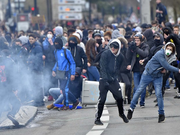Manifestantes jogam pedras contra a polícia durante protesto contra reforma trabalhista nesta quinta-feira (31) em Nantes (Foto: LOIC VENANCE / AFP)