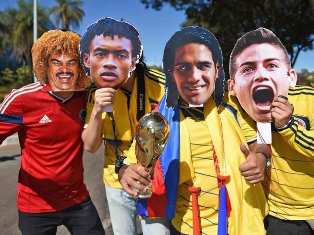 Torcedores colombianos posam com fotos gigantes dos ídolos Carlos Valderrama, Juan Cuadrado, Radamel Falcao e James Rodriguez. O registro foi feito em frente ao Estádio Mané Garrincha. A seleção sul-americana enfrenta a Costa do Marfim na segunda rodada d (Foto: G1DF)
