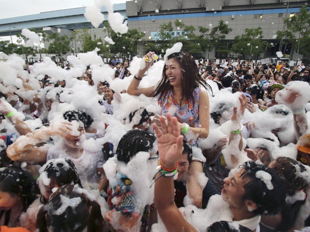 Algumas pessoas usaram até óculos de sol e de natação para aproveitar a brincadeira (Foto: Koji Sasahara/AP) Algumas pessoas usaram até óculos de sol e de natação para aproveitar a brincadeira (Foto: Koji Sasahara/AP)