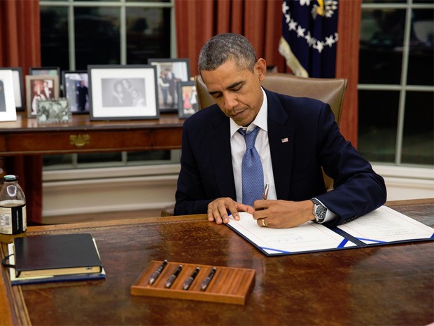 O presidente dos EUA, Barack Obama, assina legislação garantindo pagamento aos membros das Forças Armadas (Foto: Pete Souza/White House)