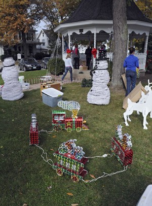 Voluntários decoram o 'Adams Street Park' para criar um clima de Natal na cidade. (Foto: AP Photo/News Herald, Jonathon Bird)